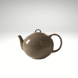 May include: A smooth, glossy, taupe-colored ceramic teapot with a rounded, spherical body, a curved spout, a circular handle, and a matching lid featuring a small, arched handle on top. The teapot has a solid, uniform finish throughout.