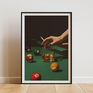 May include: A framed print depicting a still life scene with a glass of whisky with ice, a lit cigarette, and several billiard balls on a green felt table. The balls are numbered and coloured.