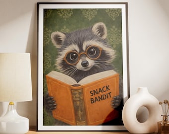 May include: Framed art print featuring a raccoon wearing glasses and reading a book. The book is open, displaying the words "SNACK BANDIT" on the orange cover. The background has a green floral pattern.