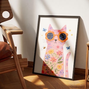 May include: A framed art print featuring a pink cat wearing flower-shaped sunglasses. The cat is decorated with colorful flowers and butterflies. A bee and stars are also included in the design. The artwork is in a black frame.