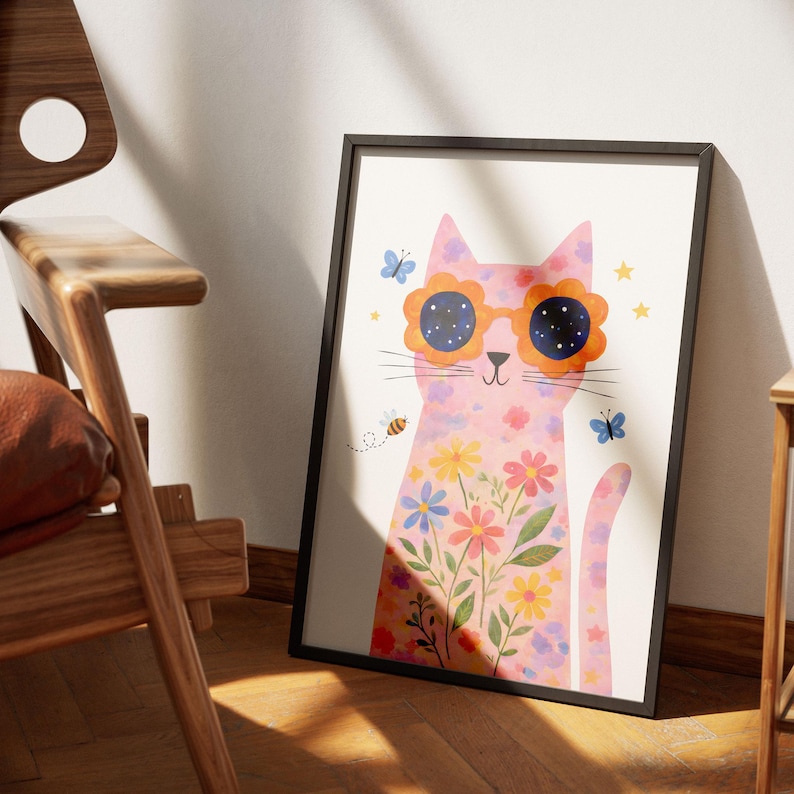 May include: A framed art print featuring a pink cat wearing flower-shaped sunglasses. The cat is decorated with colorful flowers and butterflies. A bee and stars are also included in the design. The artwork is in a black frame.