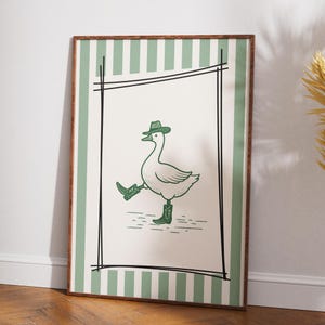 Arte de pared imprimible de ganso vaquero, póster de pato del oeste, decoración de ganso adorable y divertida, arte de guardería con rayas verdes, obra de arte rústica vintage de vaquero