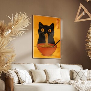 May include: A framed poster featuring a black cat eating ramen noodles from a red bowl. The cat's silhouette is against a yellow background. The poster has Japanese text in the upper right corner and a black chopstick.