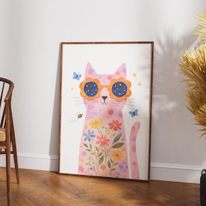 May include: A framed art print featuring a whimsical pink cat adorned with flower-shaped sunglasses. The cat's body is decorated with colorful flowers and butterflies. A bee is flying near the cat. The artwork is set against a white background.