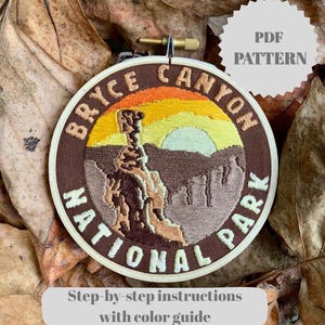 May include: Embroidered patch featuring the Bryce Canyon National Park landscape. The design includes a sunset, rock formations, and the text "BRYCE CANYON NATIONAL PARK." The patch is in a wooden embroidery hoop. The text "PDF PATTERN" and "Step-by-step instructions with color guide" are also visible.