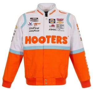 May include: White and orange racing jacket with the word "HOOTERS" in large orange letters across the chest. The jacket has multiple sponsor logos and patches, including "NASCAR CUP SERIES" and "NAPA". Light blue accents are present.