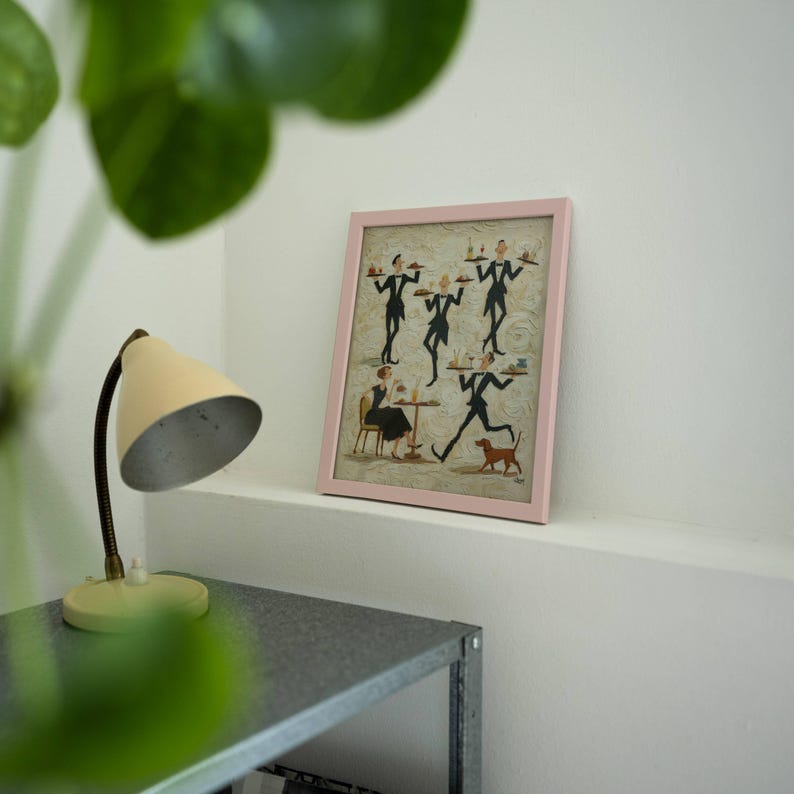 May include: A framed print with a pink border. The artwork depicts stylized figures of waiters carrying trays, a woman seated at a table, and a dog. The print is displayed on a white shelf.