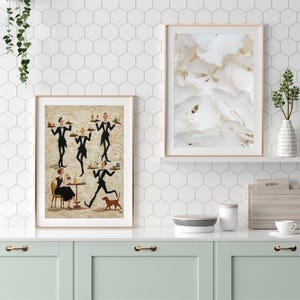 May include: Two framed art prints. One features a painting of waiters in black suits carrying trays, a woman at a table, and a dog. The other print is a close-up of white flower petals. The prints are displayed above a mint green cabinet.