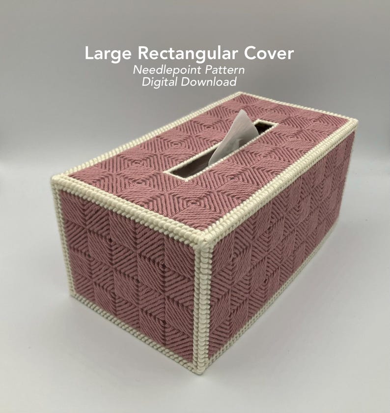 May include: A rectangular tissue box cover in a dusty rose color, featuring a geometric needlepoint pattern. The cover has a cream-colored border and a rectangular opening for tissue access. The text "Large Rectangular Cover" is visible.