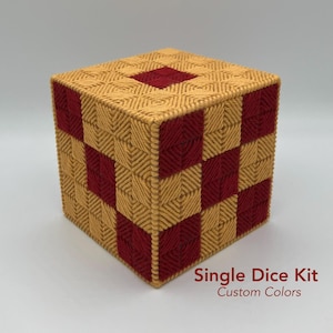May include: A handcrafted cube-shaped tissue box cover. The cover is made of woven yarn in a checkerboard pattern of gold and burgundy. The text "Single Dice Kit Custom Colors" is printed on the bottom right.