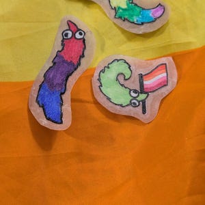 Custom worm on a string pride flag sticker