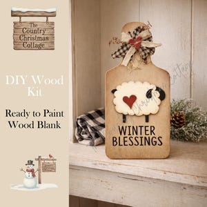 May include: A wooden DIY kit with a sheep design and the words "Winter Blessings." The kit includes a wooden sign with a sheep cutout, a red heart, and a decorative bow. The sign is ready to paint.