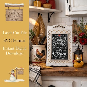 May include: A decorative kitchen sign with the text "A Cozy Home Starts in the Kitchen" in white script on a black chalkboard. The sign is in a white, ornate frame. A ceramic rooster jar and a snowman sign are also visible.