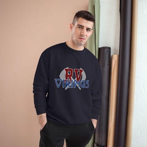 May include: Navy blue sweatshirt with the text "RV Vikings" in red, white, and blue. The graphic features a football-shaped design. The sweatshirt is a long-sleeved crew neck.