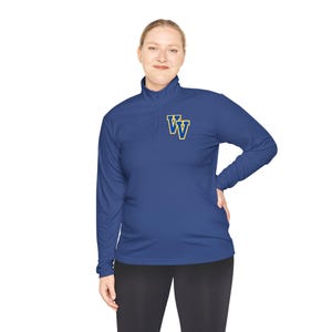 May include: A navy blue long-sleeve athletic shirt with a quarter-zip collar. The shirt features a gold and blue double "W" logo on the chest. The model is wearing black leggings.