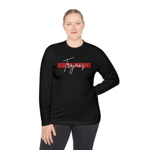 May include: Black long-sleeve shirt with the text "NOR/Trojanono" in red and white script. The shirt is made of a soft, comfortable material.