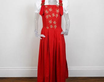 May include: A red dress with a white blouse and gold-colored accents. The dress features a square neckline, embroidered starburst designs, and a long skirt. The white blouse has ruffled sleeves.