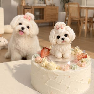 May include: A round white frosted cake topped with a sculpted white dog figurine featuring a pink bow with pearls. The cake is decorated with piped pastel frosting swirls, small white pearl accents, and sliced fresh strawberries on top.