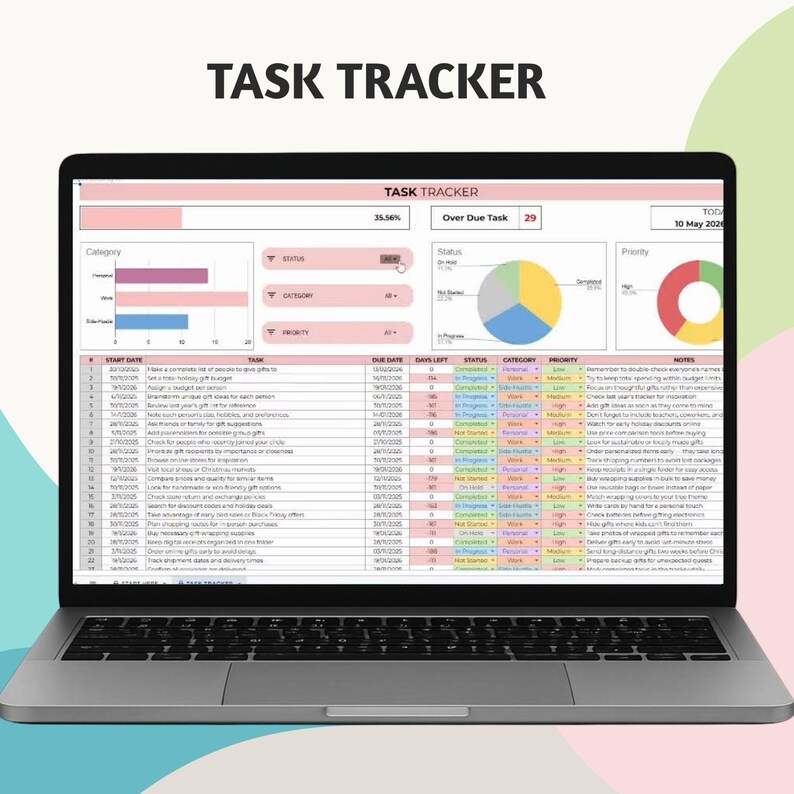 May include: A laptop screen showing a task tracker spreadsheet. The display includes data tables, charts, and the text "TASK TRACKER". The laptop is open, revealing the keyboard, and is positioned on a light surface.