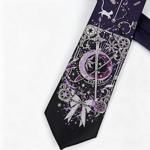 May include: A dark purple necktie featuring a silver and light purple graphic print of a sword, a crescent moon, a bow, stars, and a cat silhouette. The design includes intricate filigree patterns and celestial motifs across the fabric.