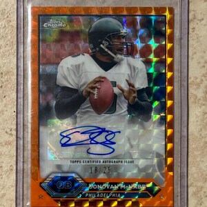 May include: A Topps Chrome football trading card featuring Donovan McNabb of the Philadelphia Eagles. The card has an orange border and includes an autograph. The card is labeled as a "Topps Certified Autograph Issue" and is numbered 18/25.