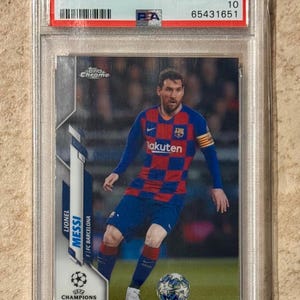 Puede incluir: Una tarjeta coleccionable de Lionel Messi Topps Chrome UCL 2019-20, calificada GEM MT 10 por PSA. La tarjeta muestra a Messi con la camiseta azul y roja del Barcelona, jugando al fútbol en un campo verde. La tarjeta está en un estuche protector transparente.