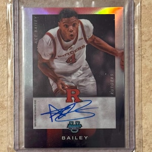 May include: A Topps certified autograph issue sports trading card featuring Ace Bailey of Rutgers. The card has a silver border and includes Bailey's signature in blue ink. The Rutgers logo is visible on the player's jersey.