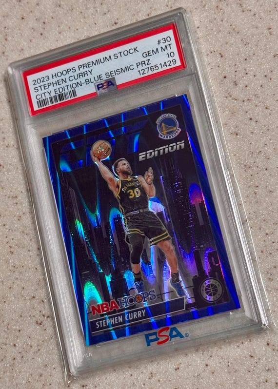 Stephen Curry 2023 Hoops City Edition Blue Seismic Prizm #d/99 PSA