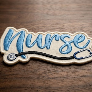 May include: Embroidered patch with the word "Nurse" in light blue script. A black stethoscope with blue accents is attached to the word. The patch has a cream-colored background and a white border.