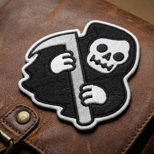 Grim Reaper Embroidered Patch - Cute Death Scythe Iron On Patch - Gothic Skull Badge for Backpacks - Halloween Spooky Applique