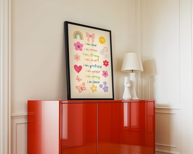 This vibrant digital download features a collection of kids' daily affirmations designed to inspire confidence. The artwork includes uplifting phrases such as "I am kind," "I am brave," and "I am loved," beautifully surrounded by colorful illustrations of flowers, a sun, a rainbow, and butterflies. Perfect for decorating a child's room, playroom, or nursery, creating an uplifting environment that encourages kids to embrace a positive mindset and boosts their self-esteem.