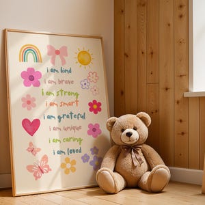 This vibrant digital download features a collection of kids' daily affirmations designed to inspire confidence. The artwork includes uplifting phrases such as "I am kind," "I am brave," and "I am loved," beautifully surrounded by colorful illustrations of flowers, a sun, a rainbow, and butterflies. Perfect for decorating a child's room, playroom, or nursery, creating an uplifting environment that encourages kids to embrace a positive mindset and boosts their self-esteem.