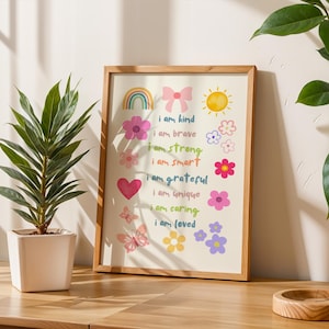 This vibrant digital download features a collection of kids' daily affirmations designed to inspire confidence. The artwork includes uplifting phrases such as "I am kind," "I am brave," and "I am loved," beautifully surrounded by colorful illustrations of flowers, a sun, a rainbow, and butterflies. Perfect for decorating a child's room, playroom, or nursery, creating an uplifting environment that encourages kids to embrace a positive mindset and boosts their self-esteem.