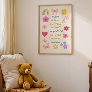 This vibrant digital download features a collection of kids' daily affirmations designed to inspire confidence. The artwork includes uplifting phrases such as "I am kind," "I am brave," and "I am loved," beautifully surrounded by colorful illustrations of flowers, a sun, a rainbow, and butterflies. Perfect for decorating a child's room, playroom, or nursery, creating an uplifting environment that encourages kids to embrace a positive mindset and boosts their self-esteem.