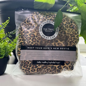 May include: A white ceramic mug with a black handle and the text "But First, Coffee" in a bold, black font. The mug is sitting on a wooden surface. The mug is approximately 4 inches tall.