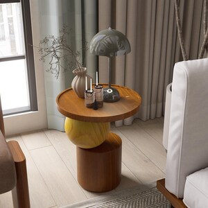 A handmade solid wood side table designed for modern and minimalist interiors. The natural wood surface shows subtle variations that highlight its unique character. Perfect for placing decor items, lighting, or everyday essentials. Ideal for living rooms, bedrooms, or office spaces, offering both functionality and a warm, refined aesthetic.