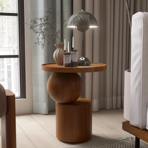 A handmade solid wood side table designed for modern and minimalist interiors. The natural wood surface shows subtle variations that highlight its unique character. Perfect for placing decor items, lighting, or everyday essentials. Ideal for living rooms, bedrooms, or office spaces, offering both functionality and a warm, refined aesthetic.