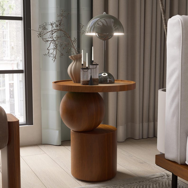 A handmade solid wood side table designed for modern and minimalist interiors. The natural wood surface shows subtle variations that highlight its unique character. Perfect for placing decor items, lighting, or everyday essentials. Ideal for living rooms, bedrooms, or office spaces, offering both functionality and a warm, refined aesthetic.