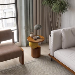 A handmade solid wood side table designed for modern and minimalist interiors. The natural wood surface shows subtle variations that highlight its unique character. Perfect for placing decor items, lighting, or everyday essentials. Ideal for living rooms, bedrooms, or office spaces, offering both functionality and a warm, refined aesthetic.