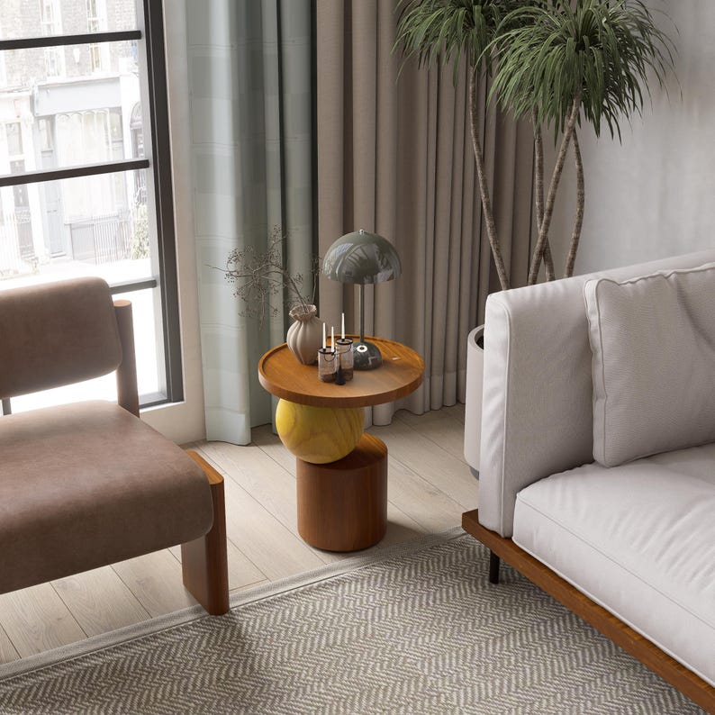 A handmade solid wood side table designed for modern and minimalist interiors. The natural wood surface shows subtle variations that highlight its unique character. Perfect for placing decor items, lighting, or everyday essentials. Ideal for living rooms, bedrooms, or office spaces, offering both functionality and a warm, refined aesthetic.