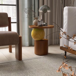 A handmade solid wood side table designed for modern and minimalist interiors. The natural wood surface shows subtle variations that highlight its unique character. Perfect for placing decor items, lighting, or everyday essentials. Ideal for living rooms, bedrooms, or office spaces, offering both functionality and a warm, refined aesthetic.