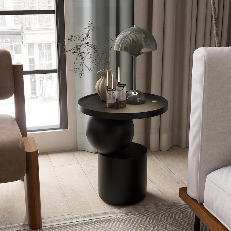 A handmade solid wood side table designed for modern and minimalist interiors. The natural wood surface shows subtle variations that highlight its unique character. Perfect for placing decor items, lighting, or everyday essentials. Ideal for living rooms, bedrooms, or office spaces, offering both functionality and a warm, refined aesthetic.