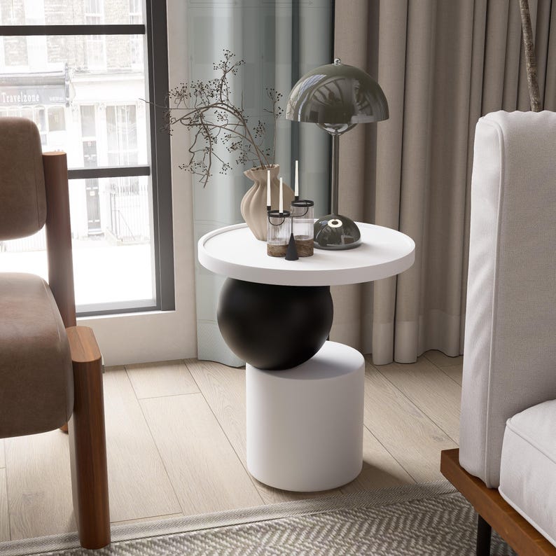 A handmade solid wood side table designed for modern and minimalist interiors. The natural wood surface shows subtle variations that highlight its unique character. Perfect for placing decor items, lighting, or everyday essentials. Ideal for living rooms, bedrooms, or office spaces, offering both functionality and a warm, refined aesthetic.