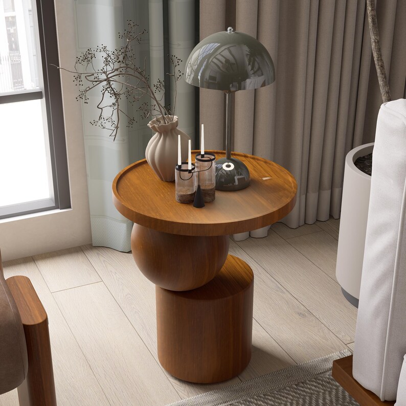 A handmade solid wood side table designed for modern and minimalist interiors. The natural wood surface shows subtle variations that highlight its unique character. Perfect for placing decor items, lighting, or everyday essentials. Ideal for living rooms, bedrooms, or office spaces, offering both functionality and a warm, refined aesthetic.