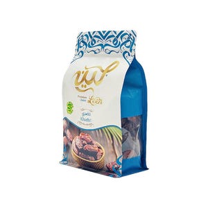 May include: A white and blue stand-up pouch containing Leen Premium Dates. The packaging features gold Arabic calligraphy, the text 'Leen', 'Premium Dates', and 'Khudhri', along with a graphic of dates in a woven basket on a wooden surface.