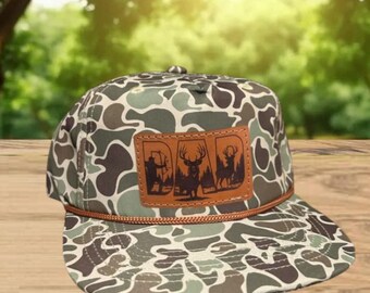 DAD Deer Hunting Leather Patch Hat | Mossy Oak Bottomland Camo Rope-Brim Snapback | Rustic Outdoor Hunter Cap