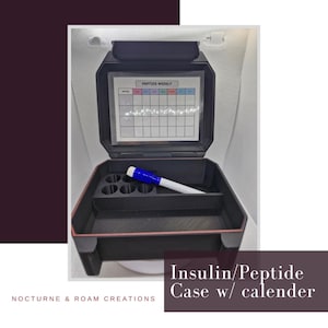 May include: A black rectangular storage case with a hinged lid featuring a clear window and a printed grid labeled PEPTIDE WEEKLY. The interior contains a built-in organizer with circular slots and a single blue and white dry erase marker.