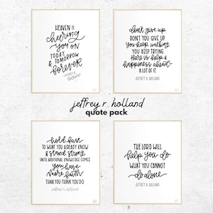 May include: A set of four rectangular wall art prints with black text on white backgrounds, framed in light wood. The prints feature inspirational quotes by Jeffrey R. Holland, including phrases like Heaven is cheering you on and The Lord will help you do what you cannot do alone. The text jeffrey r. holland quote pack and different color combos available appear in the image.