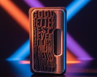 May include: A rectangular, brushed metal device with the words "GOOD BETTER BEST NEVER LET IT REST TIL YOUR GOOD IS BETTER AND YOUR BETTER IS BEST" embossed on the front. The device has a recessed area on the side. The background has blue, purple, and orange light beams.