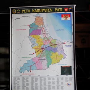 May include: A colorful map titled "PETA KABUPATEN PATI" with Indonesian text. The map shows the region's borders, roads, and key locations. The Indonesian flag is in the upper right corner. The map is displayed on a white frame.